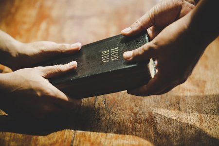 Group of people holding hands praying worship believe, devotional for prayer meeting concept